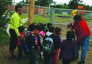Instructors greet Kindergarten students on the first day of school at Mnidoo Mnising Anishinabek Kinoomaage Gamig – the new immersion school in M'Chigeeng First Nation. 