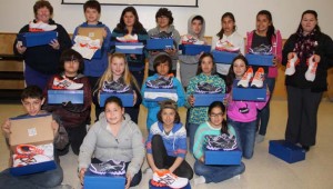 Christian Island Elementary School principal Angela Johnson, back row right, and her Grade 6-7 class hold up new runners donated by Erindale Secondary School, whose principal Sue Turner is back row, left.