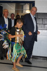 The Rt Hon. Paul Martin enters Hillside School gymnasium alongside student escort, Alex George, during the Honour Procession at the June 25th Celebration of Literacy. Following are Larry Tannenbaum and Laurence Pathy, whose charitable foundations supported the five-year partnership between Kettle and Stony Point First Nation and the Martin Aboriginal Education Initiative.