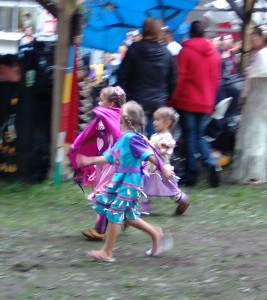 Sylvanna Muir in bright pink shawl with her younger sister Stephanie in light purple regalia