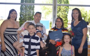 Proud graduate Winnie Wassegijig holds her diploma, surrounded by family members, back row, from left, daughter Peggy, son Donald, and daughter-in-law Wanda, and front, from left, grandchildren Bria,   Davin,  Bray and Damara.