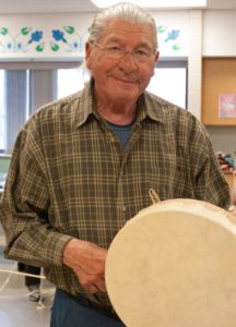 Jack Couchie, First President of the North Bay Indian Friendship Centre, and participant at the Hand Drum Workshop, displays his forty year old hand drum.