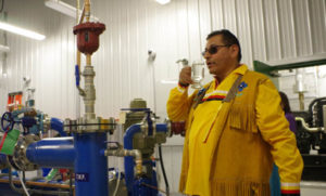 Pic Mobert Chief Wayne Sabourin tastes the water at the grand opening ceremony for the community’s new water treatment plant on June 21.