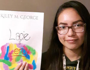 Kiley George, 14-year-old author of Nipissing First Nation with her book Lacie and Leroy.