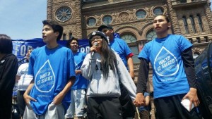Grassy Narrows youth performing song on stage at Toronto rally on June 2.